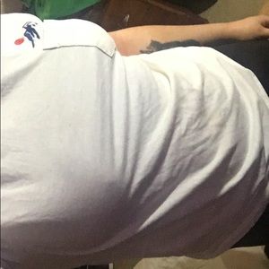 White pocket tee with mountains logo.